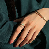 Mermaid Oval Opal East-West Ring on a Model