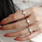 Mermaid Pear-Shaped Opal East-West Ring on a Hand