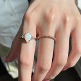 Mermaid Pear-Shaped Opal and Diamond Three-Stone Ring on a Model