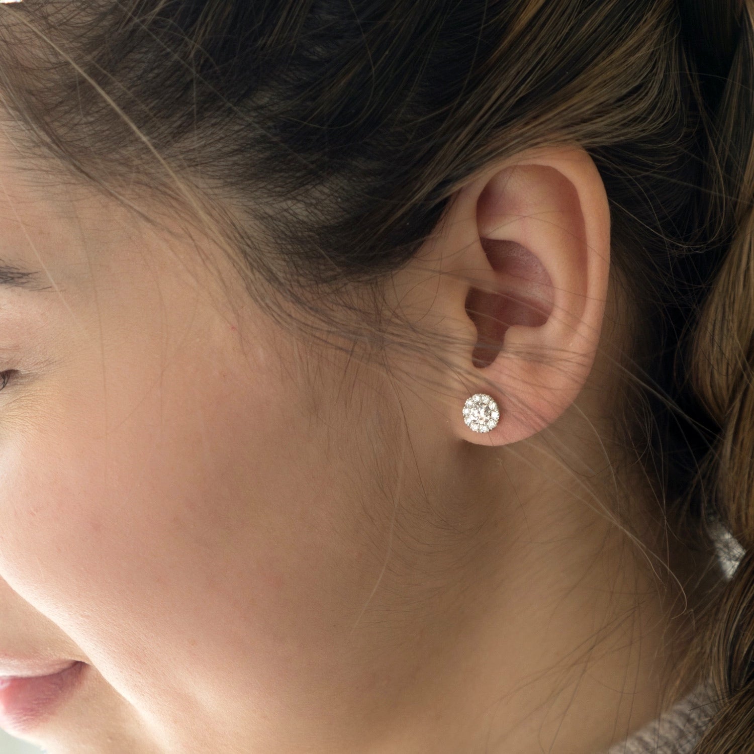 Round Brilliant Cut Diamond Halo Stud Earrings on a Model