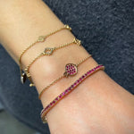 Round Cut Ruby Tennis Bracelet on a Hand