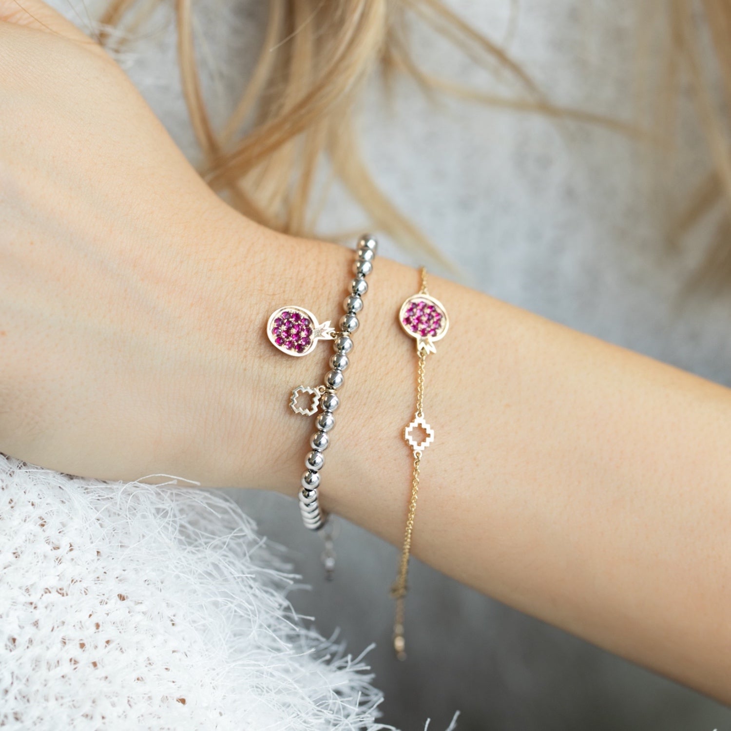 Ruby Studded Pomegranate and Step Motif Bracelet on a Hand