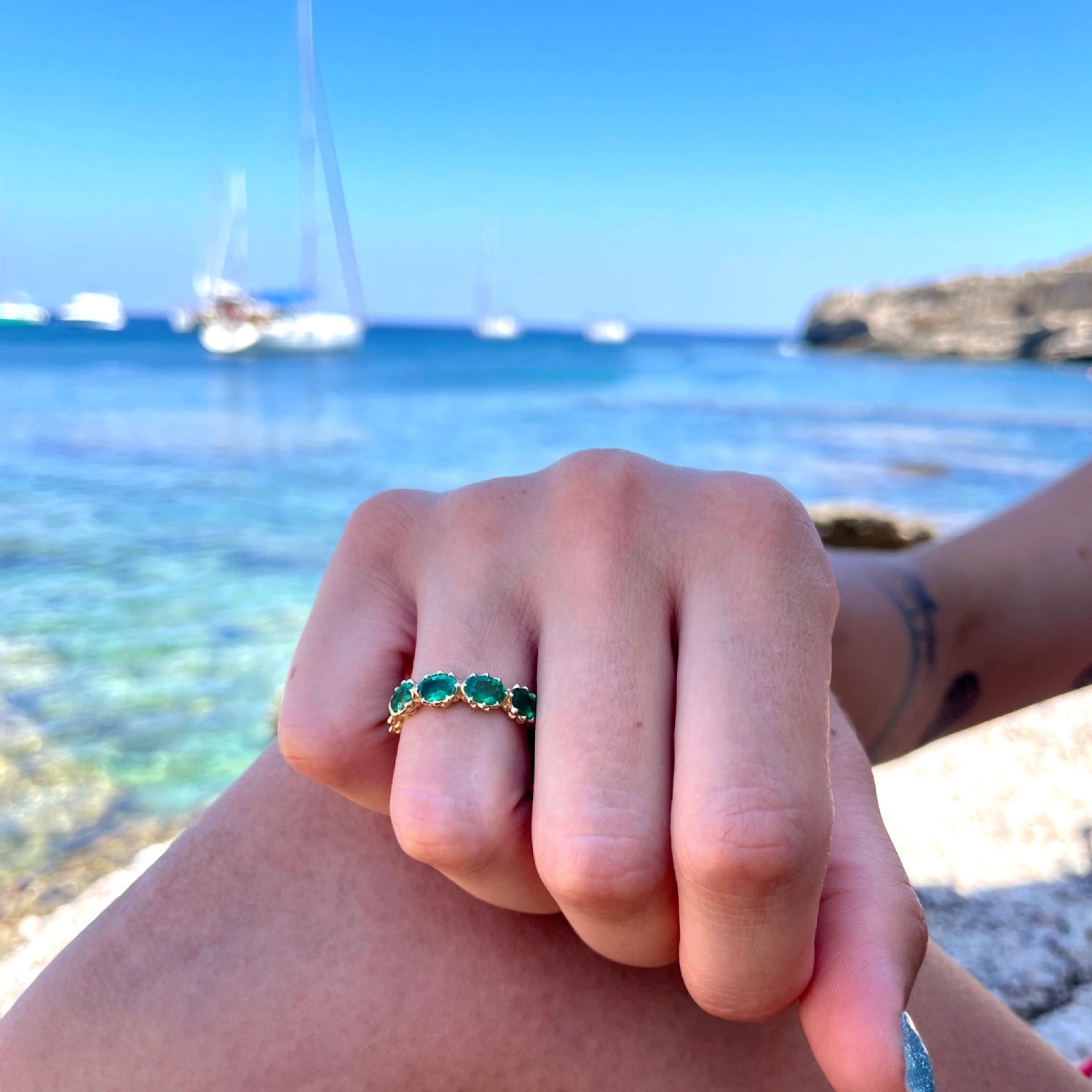 Lepia Oval Emerald Five-Stone Ring on a Hand