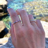 Lepia Pear-Shaped Pink and Purple Sapphire Five-Stone Ring on a Hand