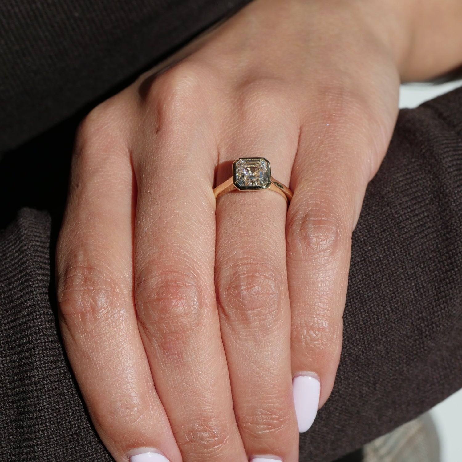 Asscher Cut Lab-Grown Diamond Bezel Solitaire Engagement Ring on a Model