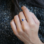 Cushion-Shaped Blue Sapphire Diamond Halo Ring on a Model