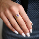 Cushion-Shaped Hot Pink Sapphire Diamond Halo Ring on a Hand