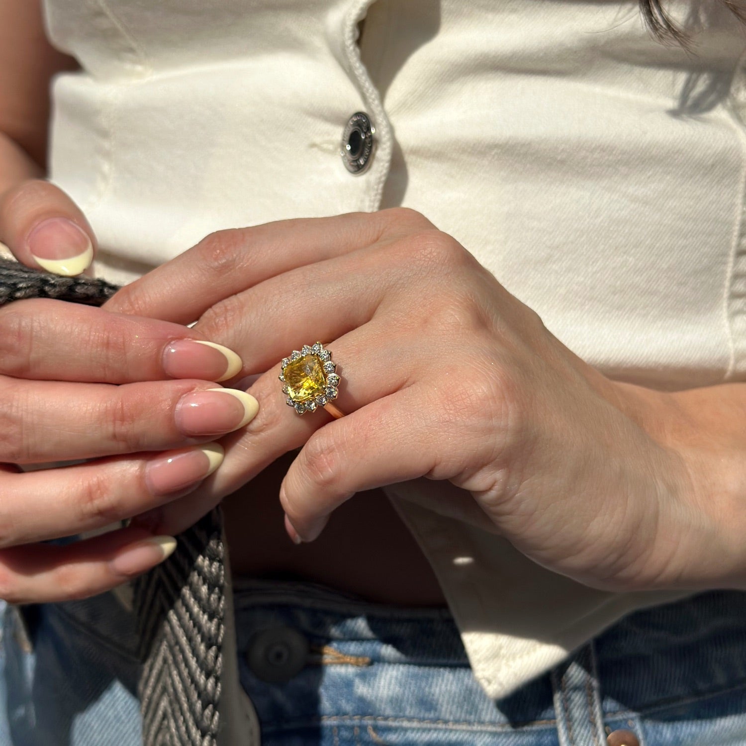Cushion-Shaped Yellow Sapphire and Diamond Sunburst Halo Ring on a Model