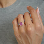Cut Corner Square Scissor Cut Pink Sapphire and Tapered Baguette Diamond Three-Stone Ring on a Model