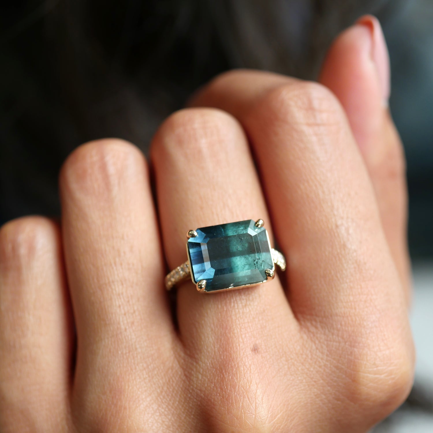 Emerald Cut Blue Tourmaline Diamond Pavé East-West Ring on a Hand