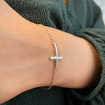 Horizontal Curved Sideways Cross Bracelet on a Hand
