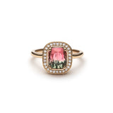 Ring with a green and pink gradient watermelon tourmaline with a Diamond halo set in yellow gold on a white background