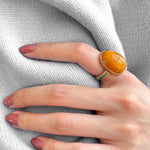 Mermaid Cabochon Amber and Round Emerald Cocktail Ring on a Hand