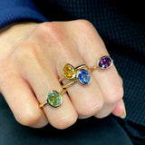 Mermaid Oval-Shaped Violet Sapphire East-West Bezel Ring on a Hand