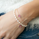 Mini Pomegranate Ruby Pavé Charm Pearl Bracelet on a Hand