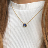 Oval-Shaped Sapphire Bezel Necklace on a Model