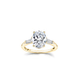 Oval and Baguette Cut Diamond Three-Stone Engagement Ring in Yellow Gold