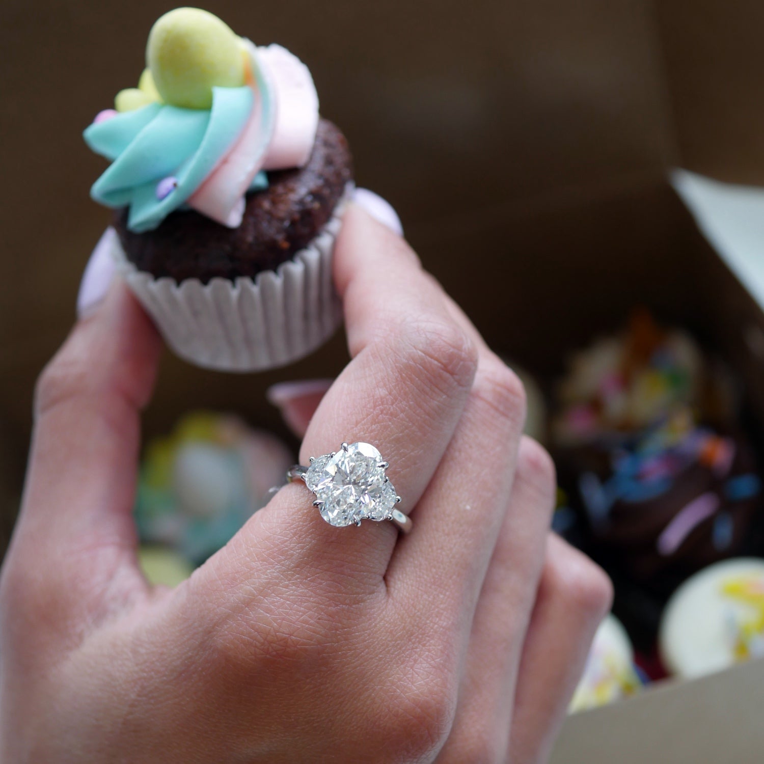Oval and Half-Moon Cut Lab-Grown Diamond Three-Stone Engagement Ring on a Model