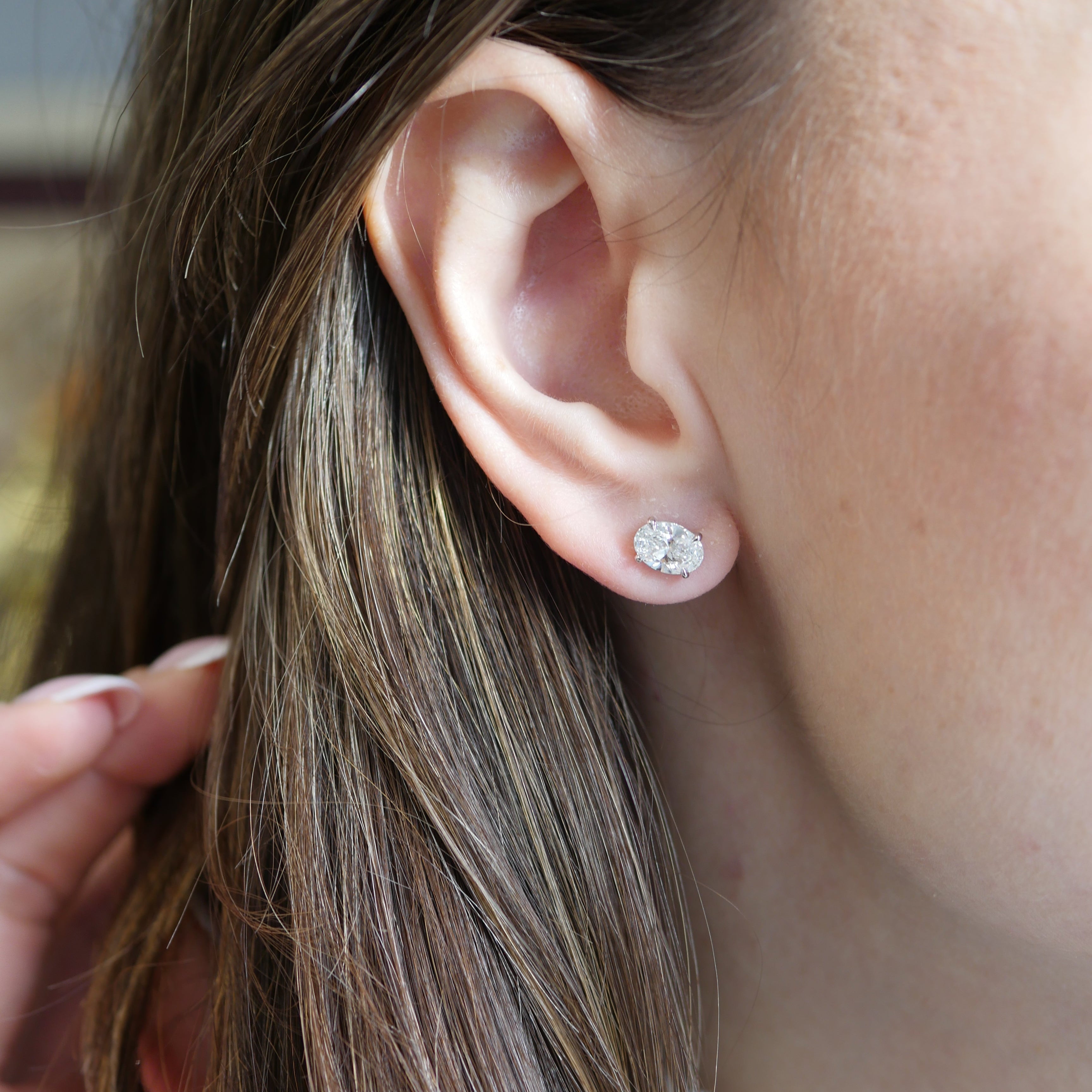 Close-up of an ear with a diamond stud earring
