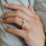 Pear-Shaped Diamond Hidden Halo Engagement Ring on a Hand