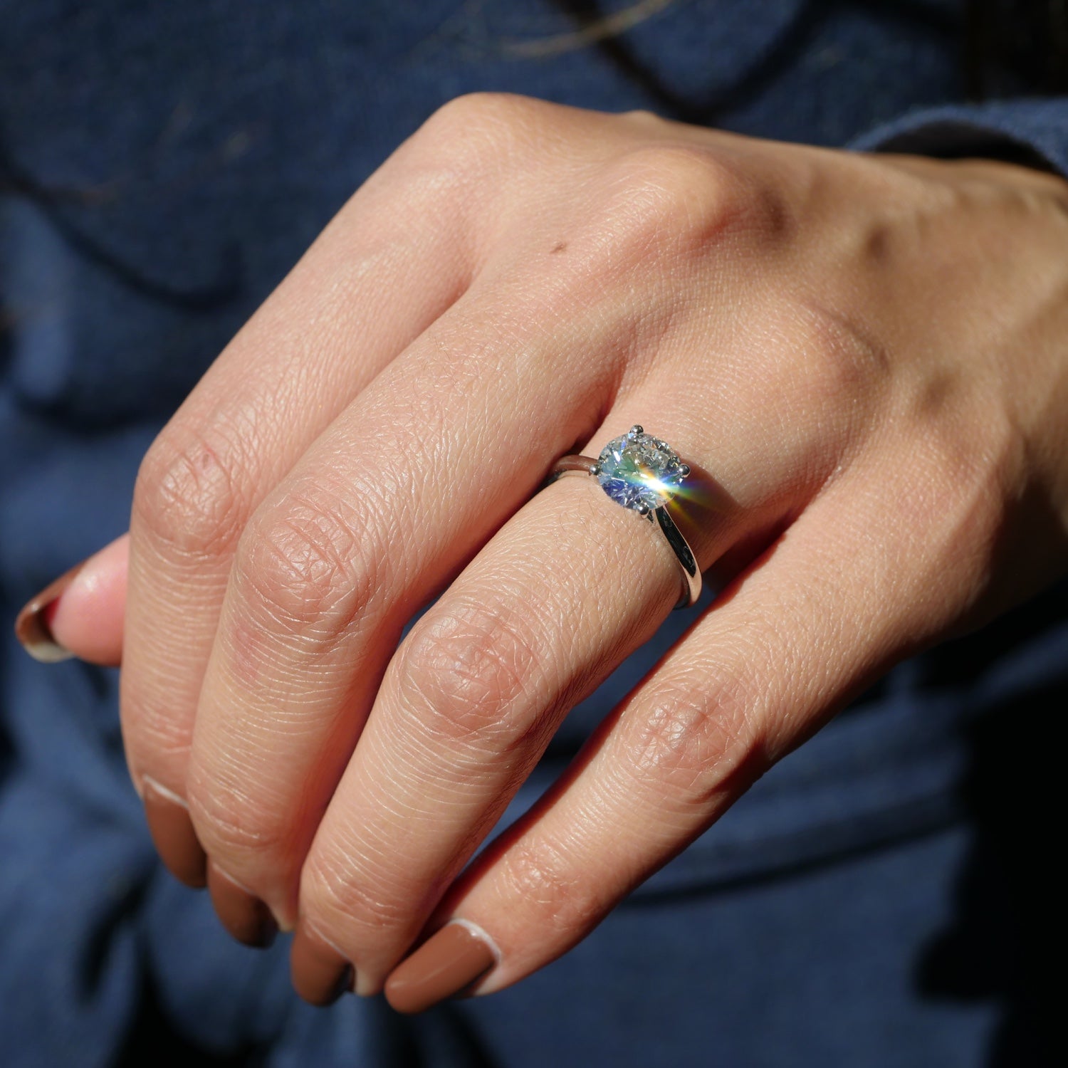 Round Brilliant Cut Lab-Grown Diamond Four-Prong Solitaire Engagement Ring on a Model