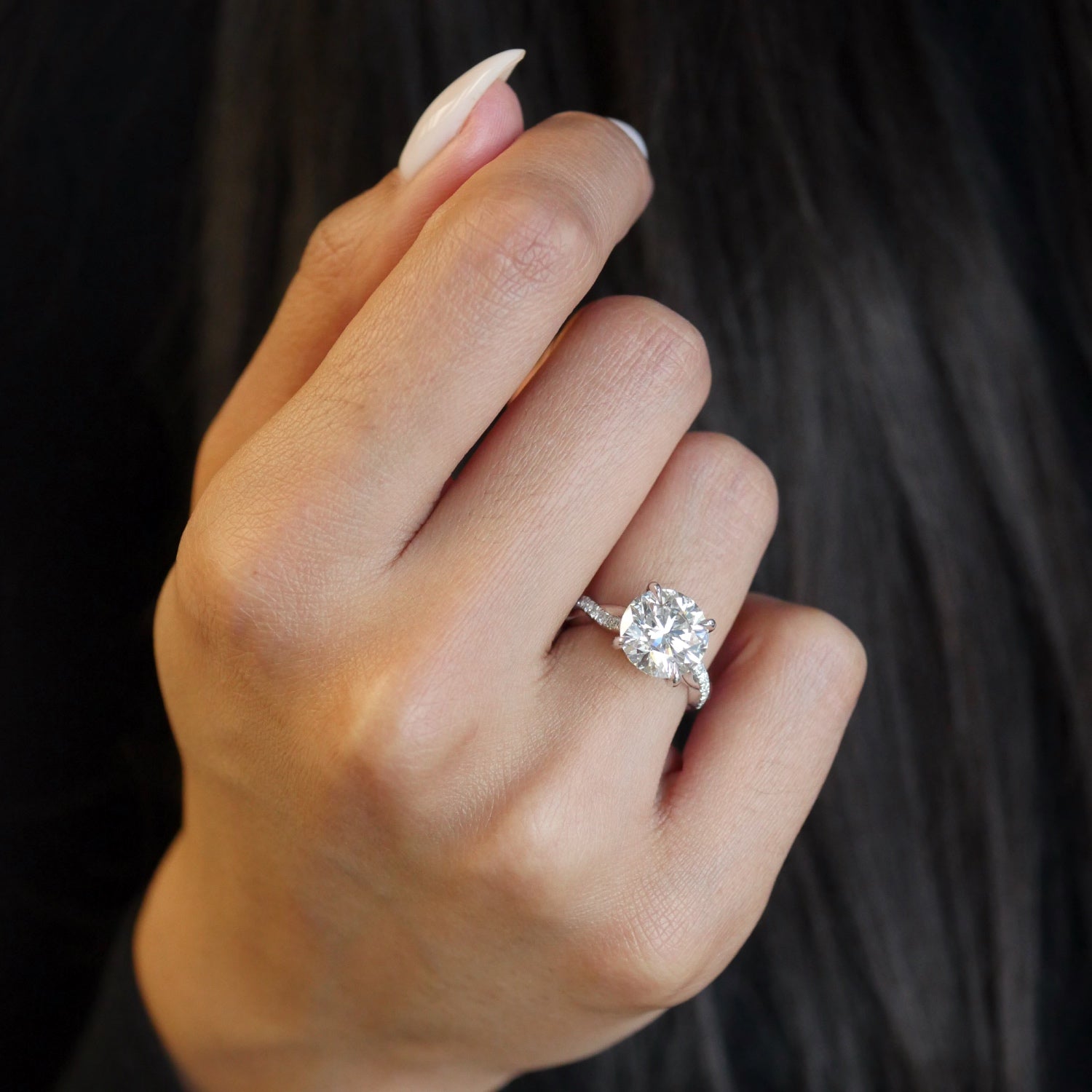 Round Brilliant Cut Lab-Grown Diamond Twisted Pavé Band Engagement Ring on a Model