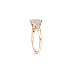 Round Brilliant and Baguette Cut Diamond Three-Stone Engagement Ring in Rose Gold Side View