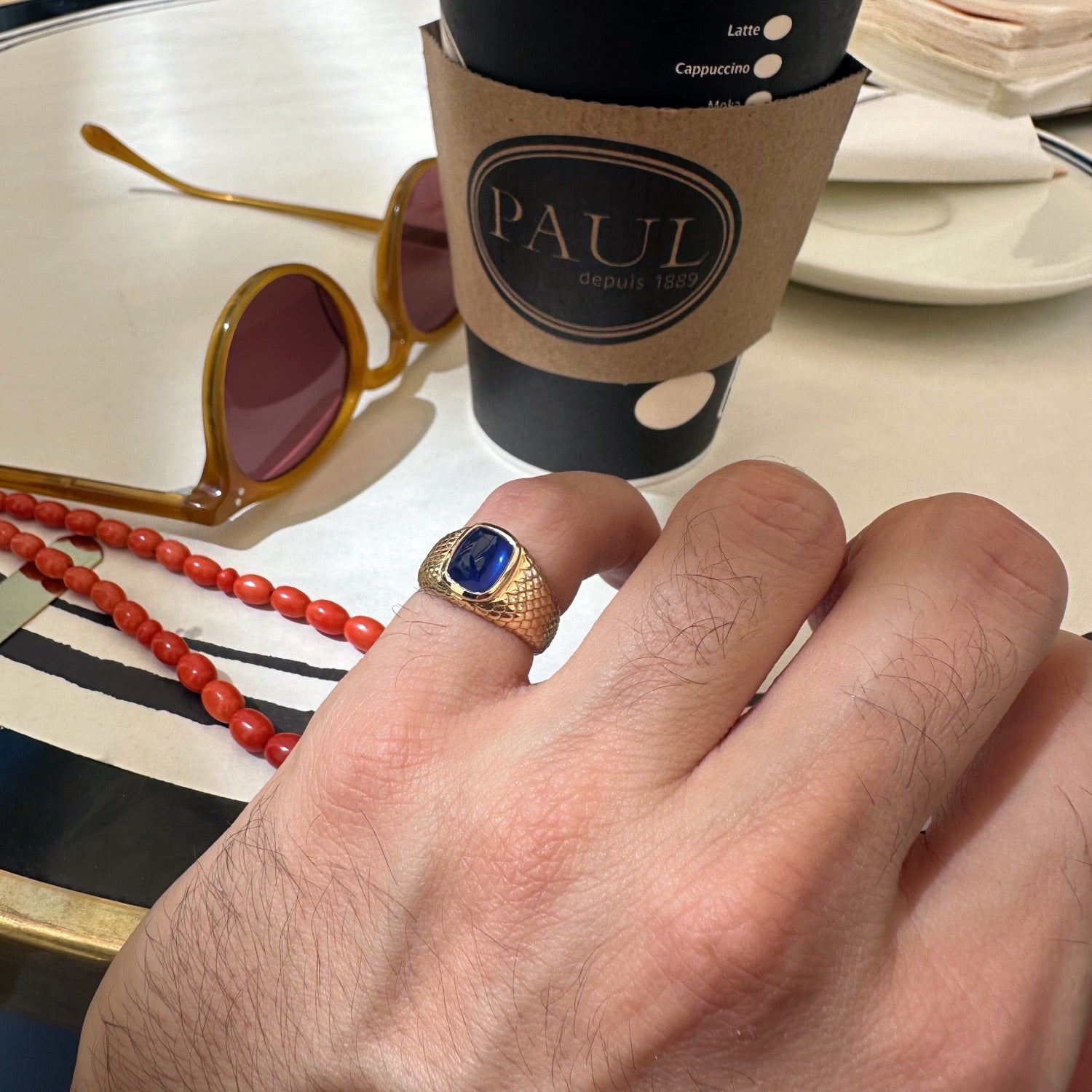 Sugarloaf Cut Blue Sapphire Textured Gold Men's Signet Ring on a Model