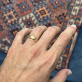 Tribal Motif Engraved Brushed Finish Bevelled Edge Men's Wedding Band on a Model