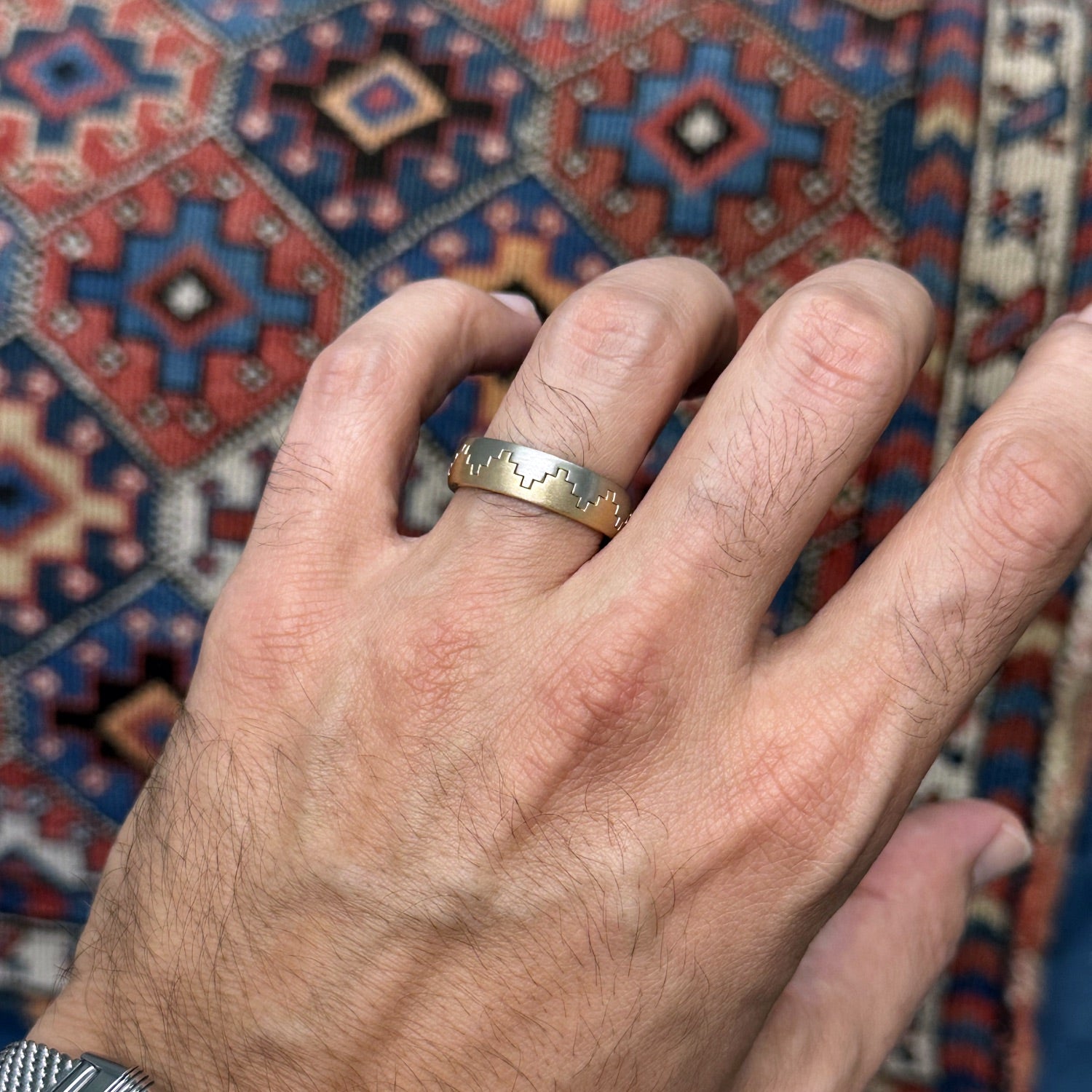 Two-Tone Yellow and White Gold Tribal Motif Men’s Wedding Band on a Model