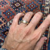 Two-Tone Yellow and White Gold Tribal Motif Men’s Wedding Band on a Model