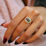 Elongated cushion cut watermelon tourmaline diamond halo east-west ring on hand