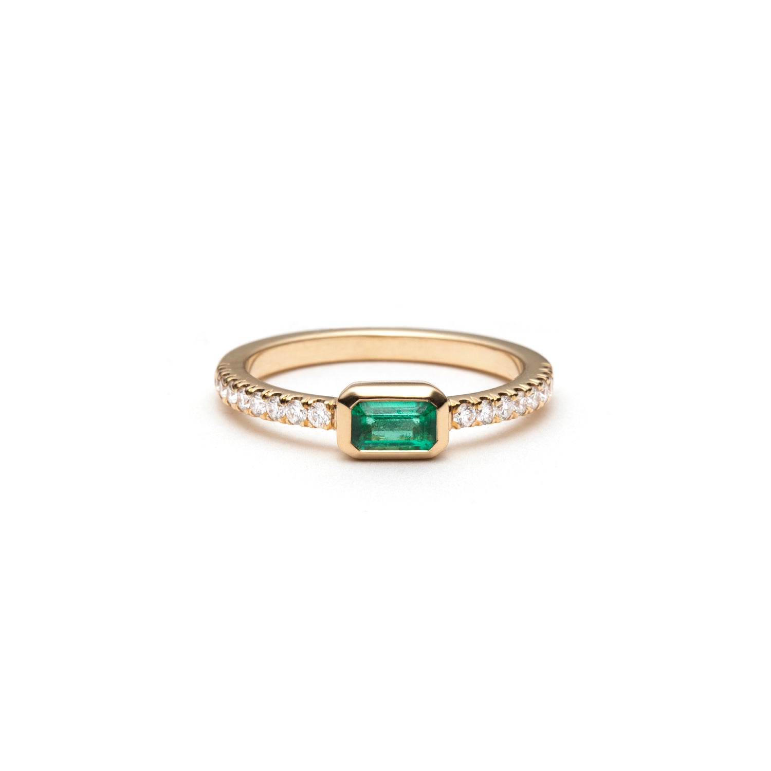 Emerald-cut emerald ring with a diamond pavé band.