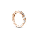 Side profile of an emerald-cut lab-grown diamond bezel half-eternity ring in rose gold, showing the settings and polished band.