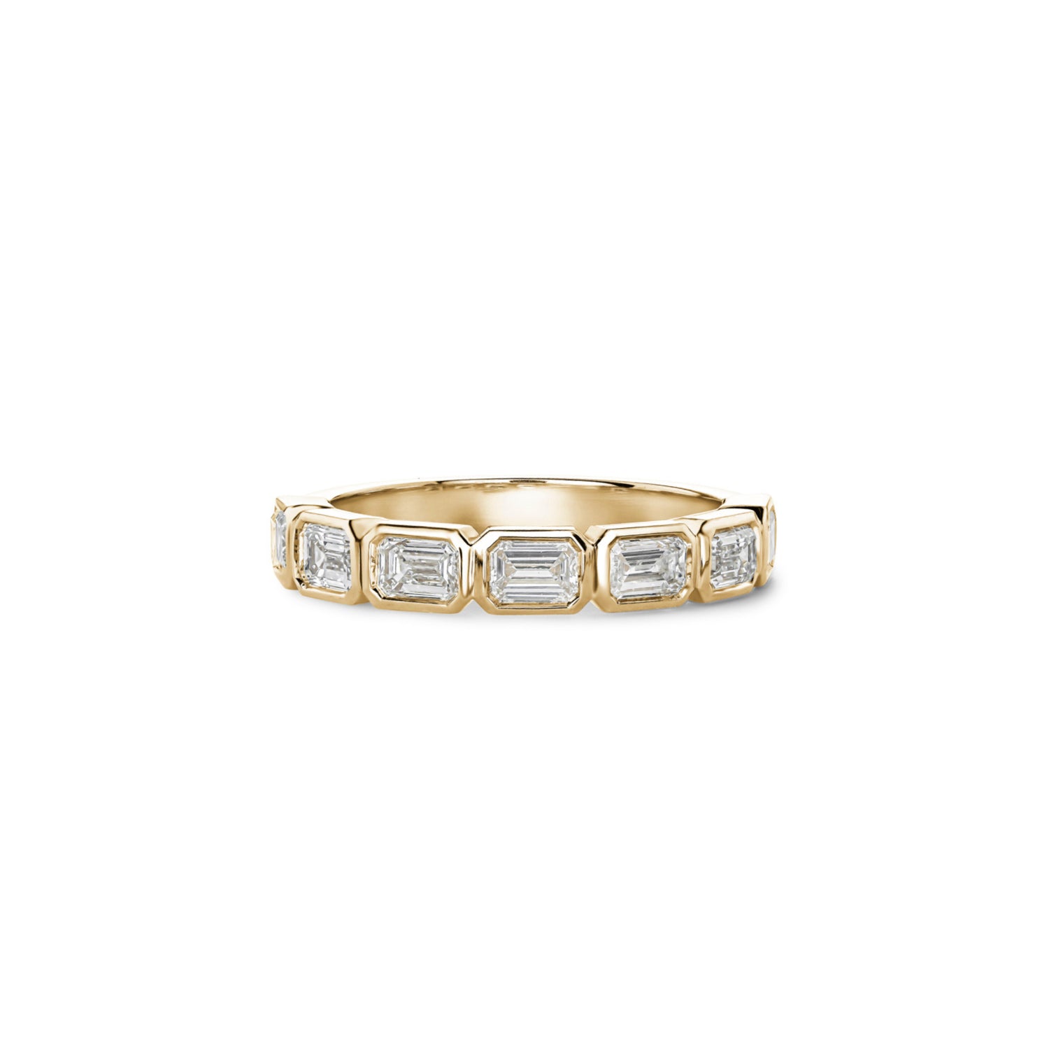 Emerald-cut lab-grown diamonds in yellow gold bezel settings across a half-eternity ring.