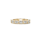 Emerald-cut lab-grown diamonds in yellow gold bezel settings across a half-eternity ring.