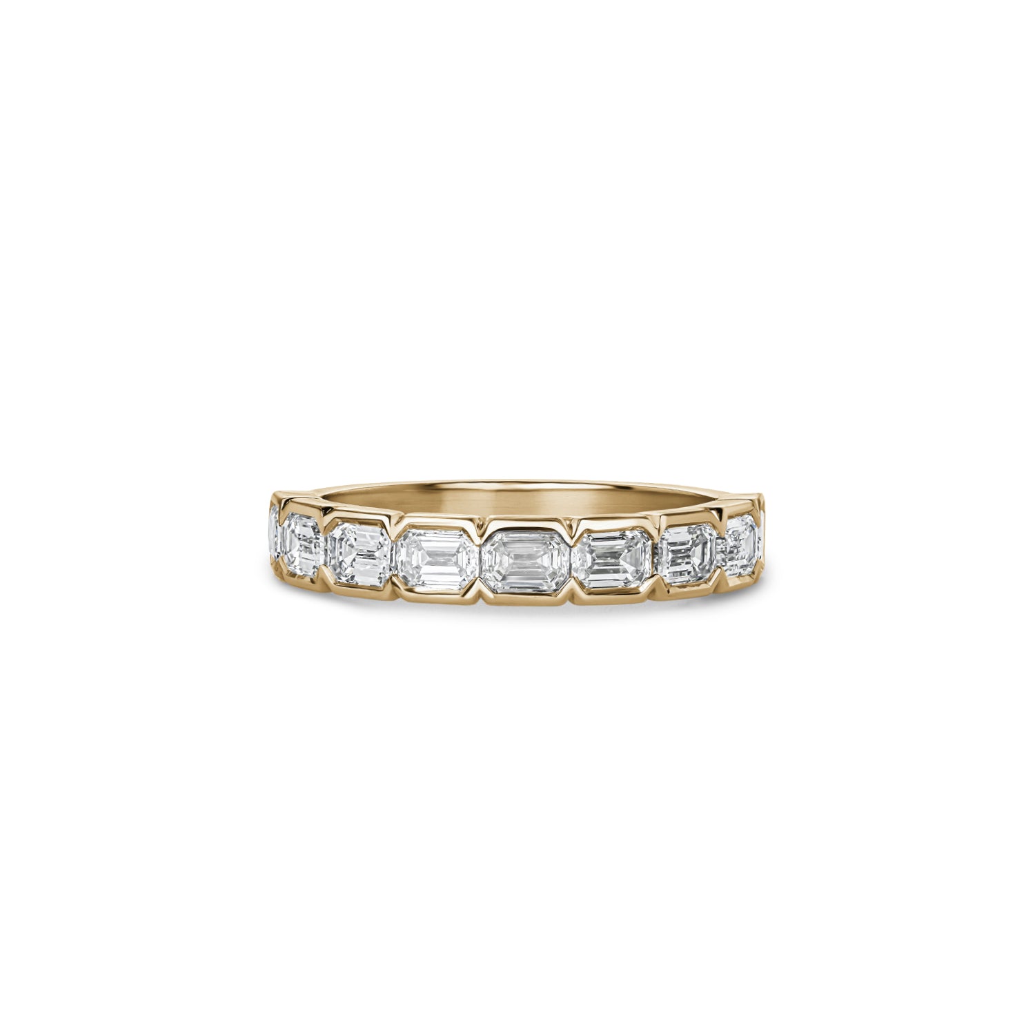 Emerald-cut lab-grown diamond half-eternity ring with half-bezel settings in yellow gold.