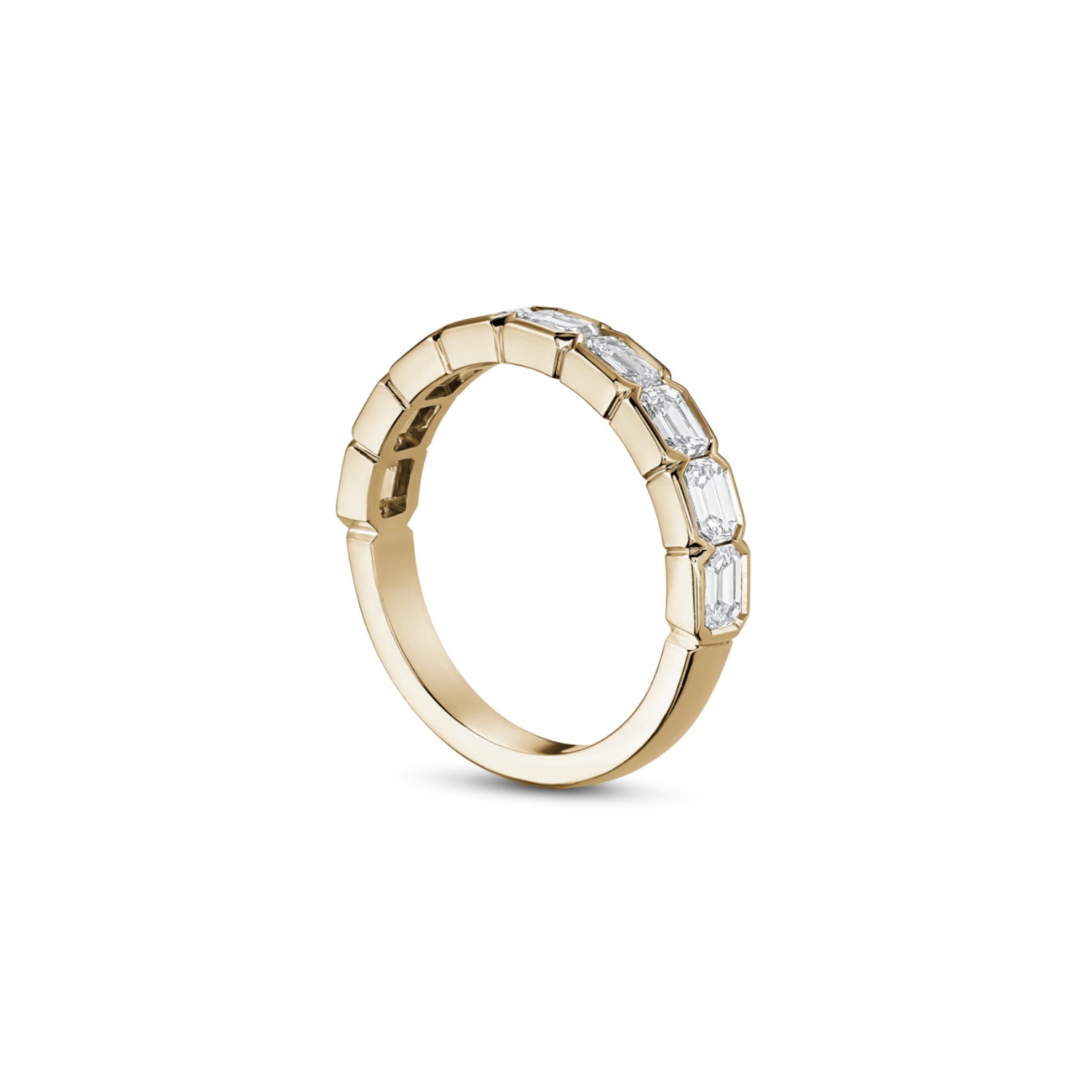 Side profile of an emerald-cut lab-grown diamond half-bezel half-eternity ring in yellow gold, showing the settings and polished band.