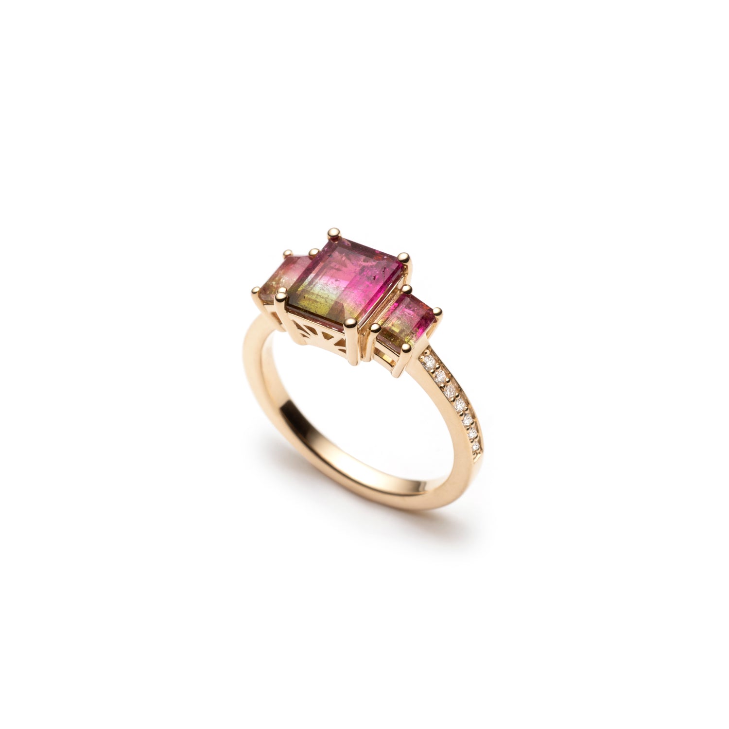 Side profile of an emerald-cut watermelon tourmaline three-stone ring, showing the gemstone settings and diamond pavé band.