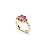 Side profile of an emerald-cut watermelon tourmaline three-stone ring, showing the gemstone settings and diamond pavé band.