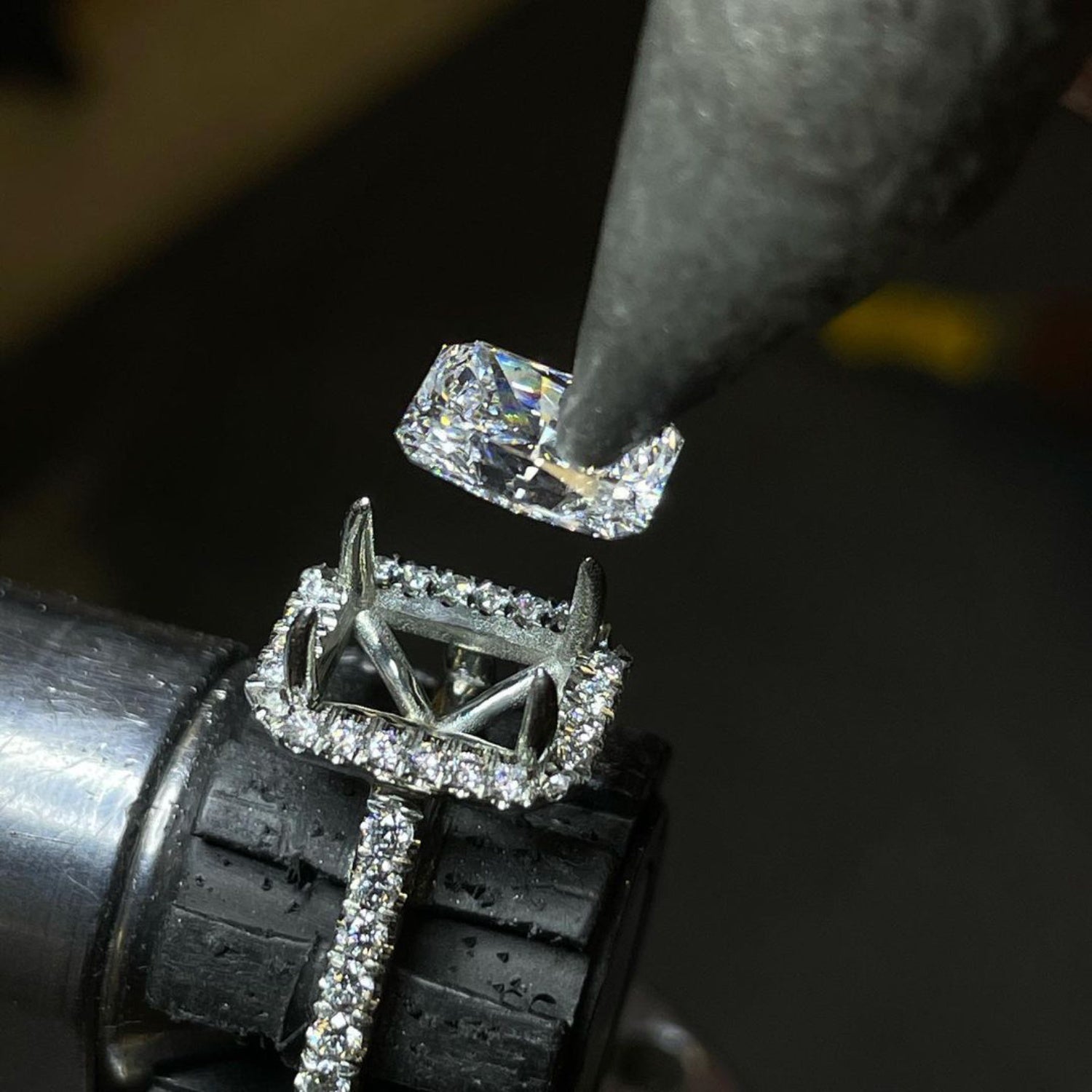 Close-up of Jivan Yeramian setting a diamond in an engagement ring held in a jeweler’s vise.