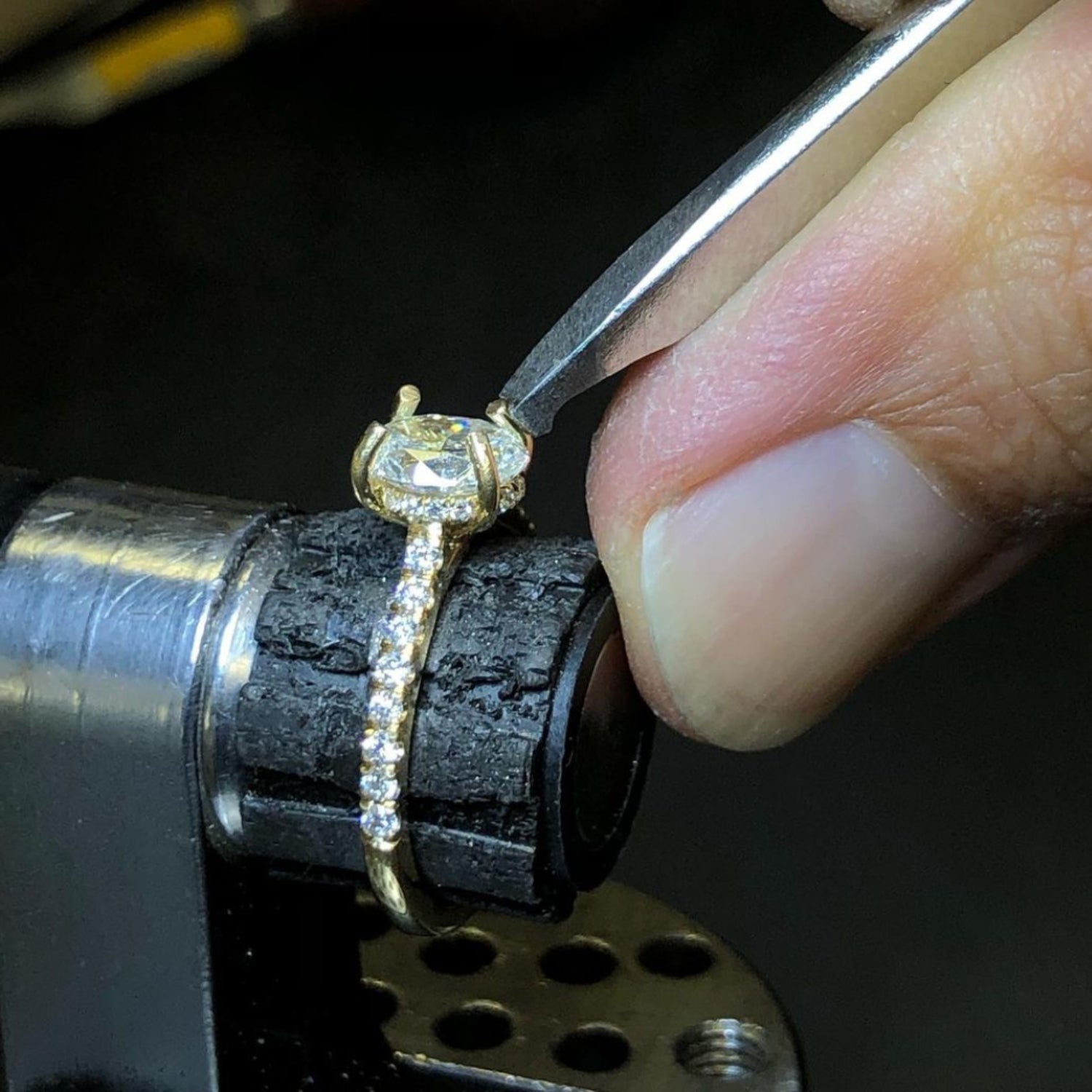 Close-up of Jivan Yeramian setting a diamond in a ring held in a jeweler’s vise.