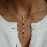 Khachkar Armenian cross pendant with sapphire accent layered with other necklaces