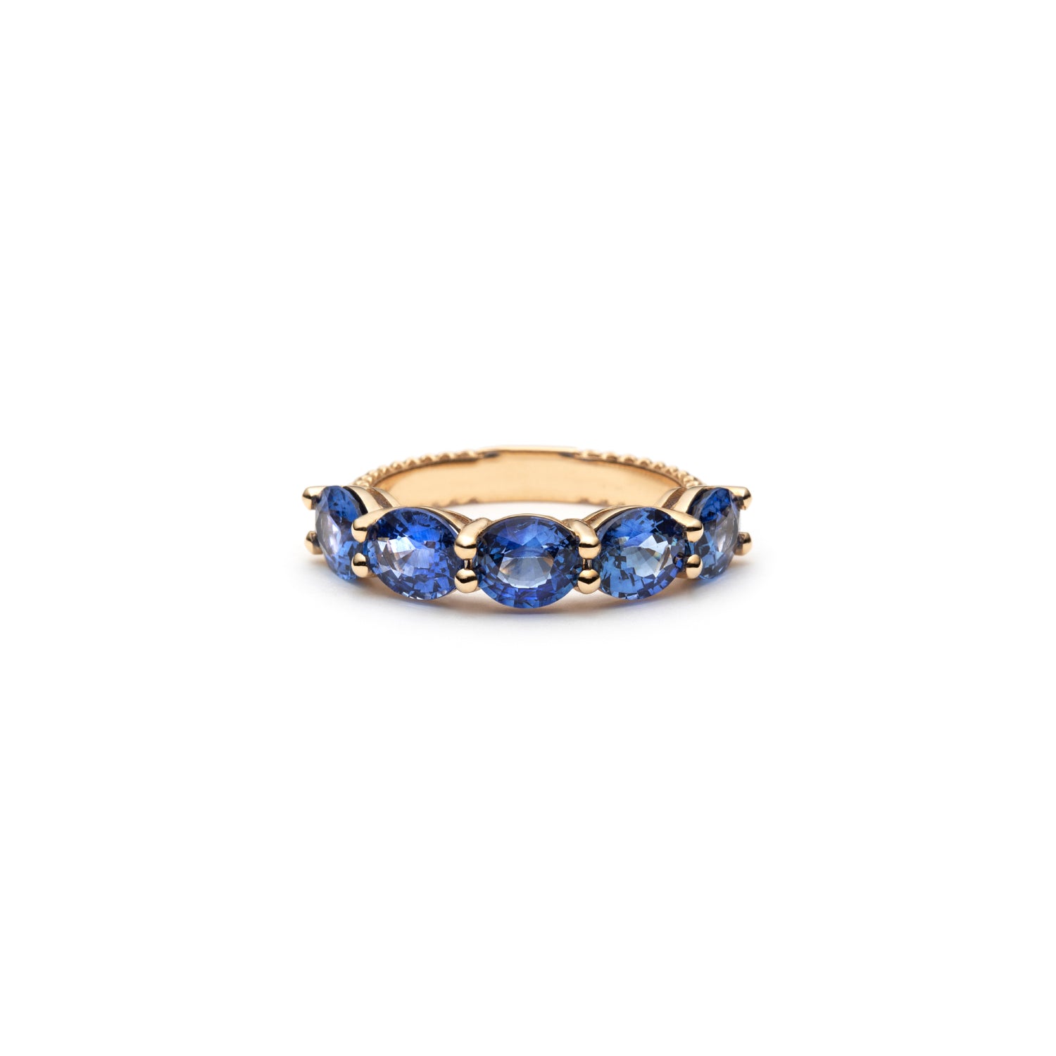 Lepia five-stone ring with oval-shaped blue sapphires set in 14K yellow gold.