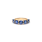 Lepia five-stone ring with oval-shaped blue sapphires set in 14K yellow gold.