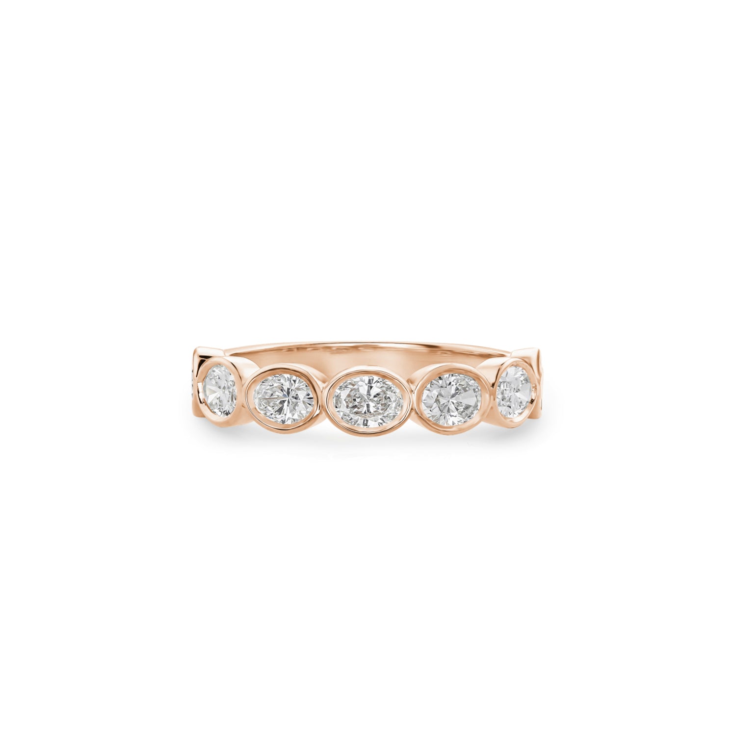 Oval-shaped lab-grown diamonds in rose gold bezel settings across a half-eternity ring.
