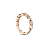 Side profile of an oval-shaped lab-grown diamond bezel half-eternity ring in rose gold, showing the settings and polished band.