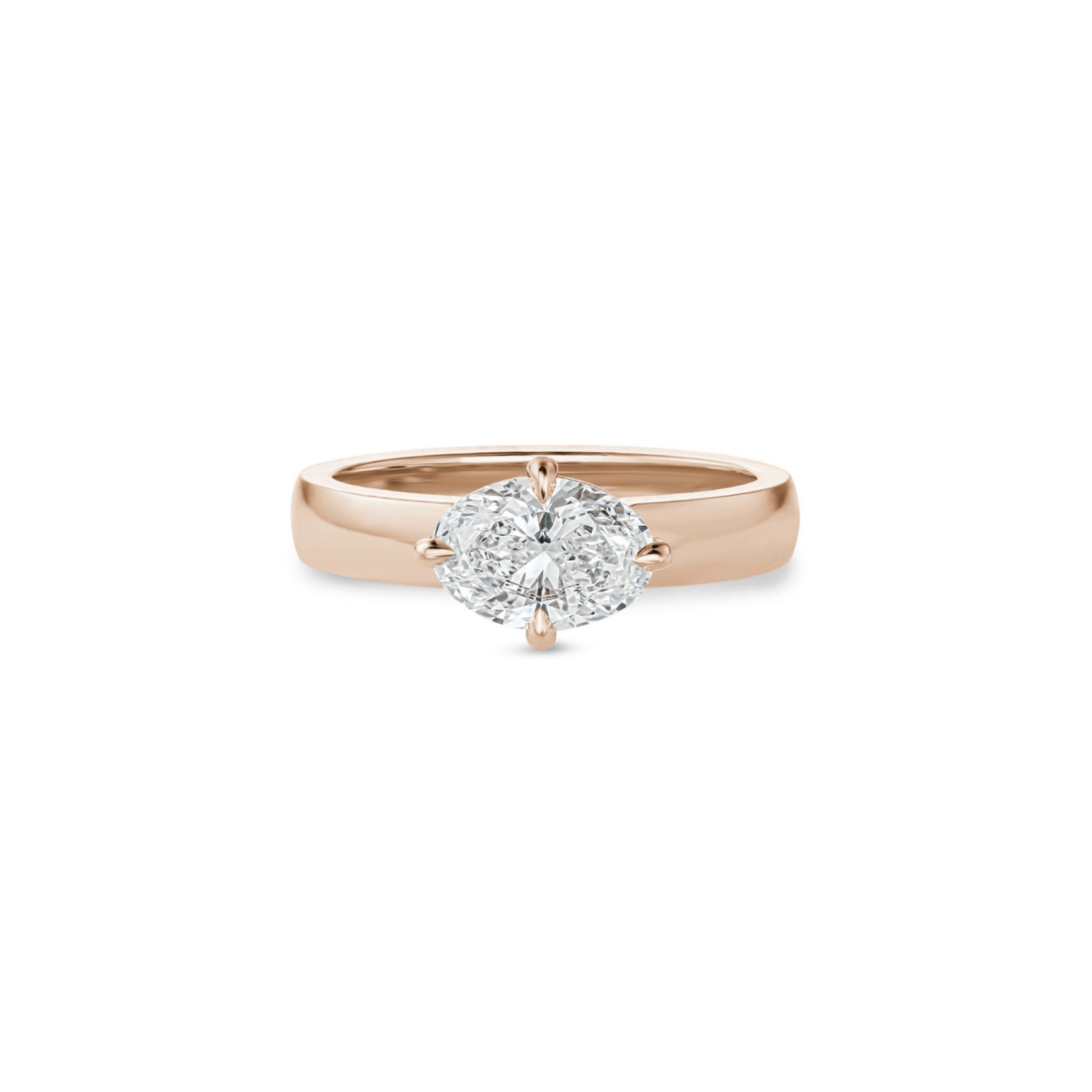 Oval-shaped lab-grown diamond set east-west in a rose gold engagement ring with a wide polished band.