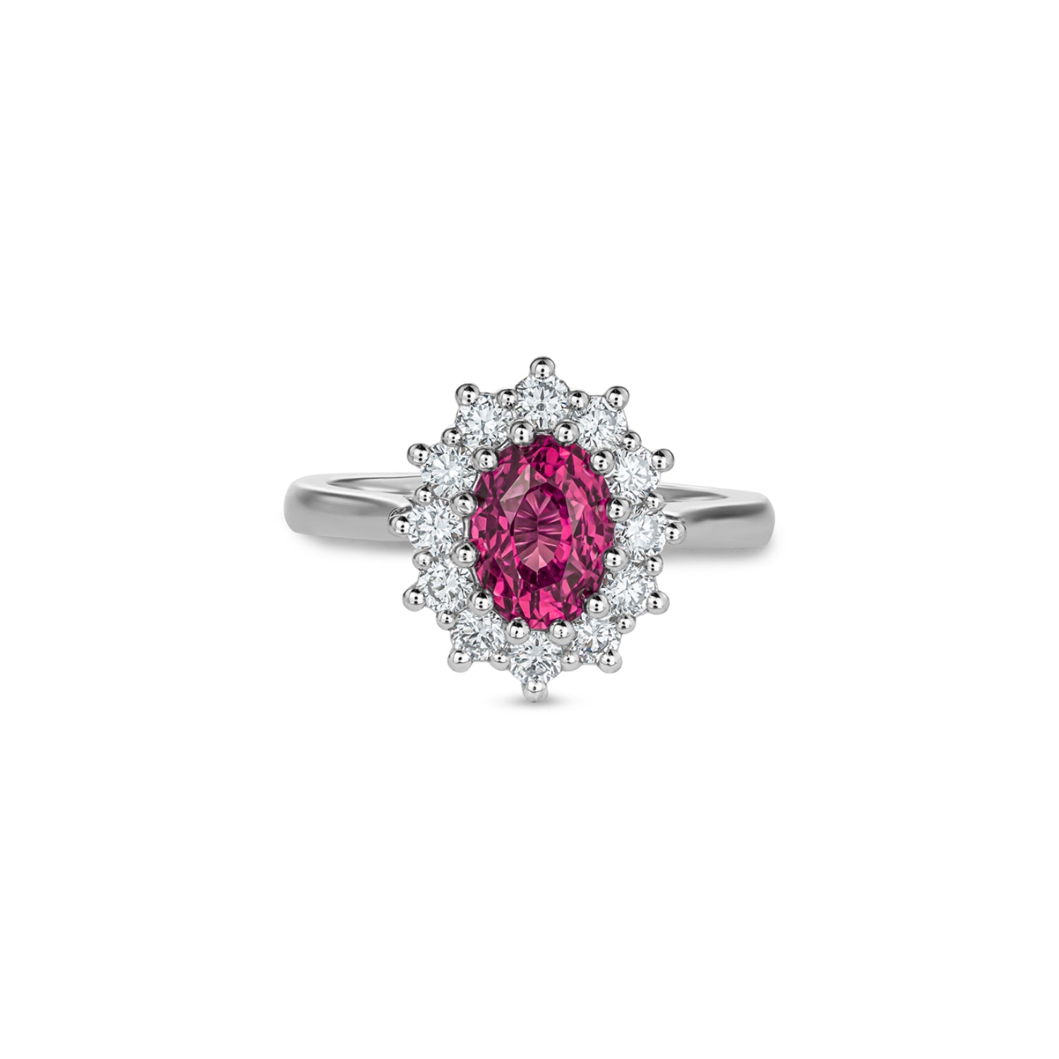 Oval-shaped pink sapphire surrounded by round brilliant-cut diamonds in a platinum cluster ring.