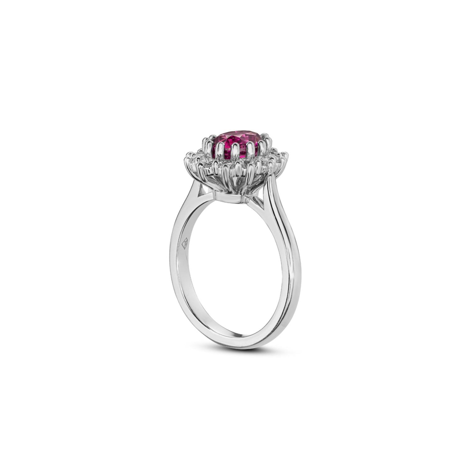Side profile of an oval-shaped pink sapphire and diamond cluster ring in platinum, showing the prong settings and polished band.